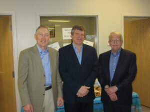 Photo of three men standing next to each other