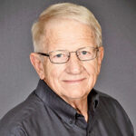 Headshot of an older man smiling